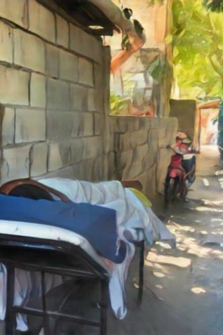 Sobreviviente de agresión en La Vega convalece en un callejón por el intenso calor dentro de su vivienda